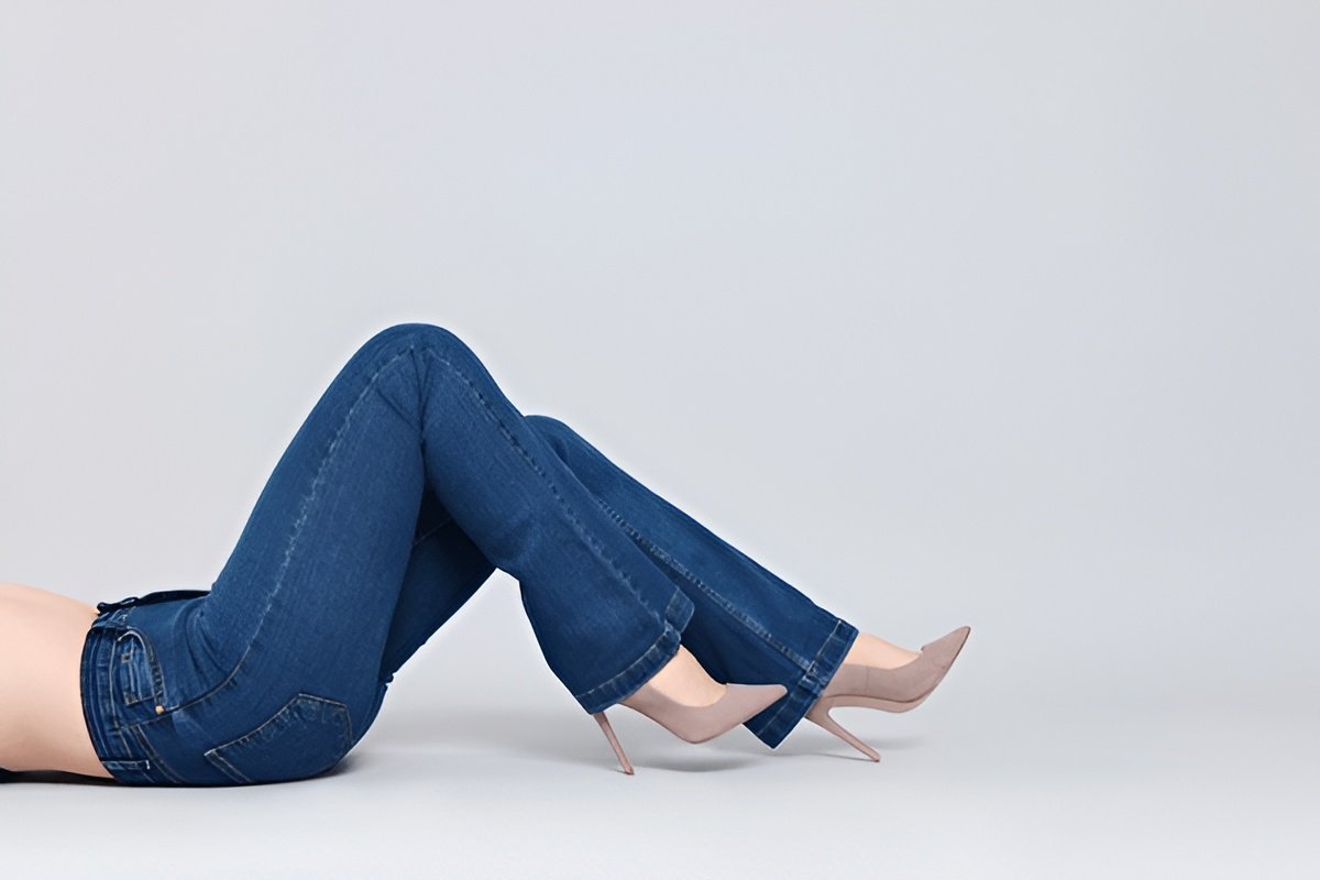 Pair of high-rise bootcut jeans worn by a woman.